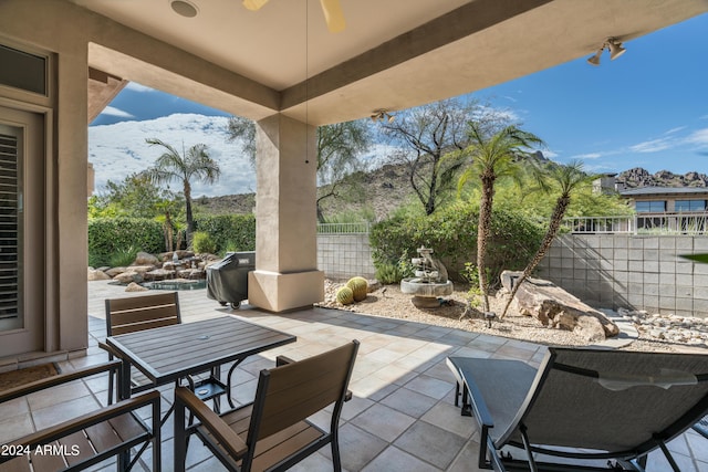 view of patio / terrace featuring area for grilling and ceiling fan