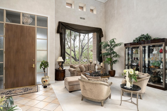 tiled entryway featuring a towering ceiling