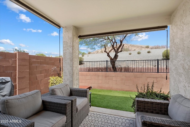 view of patio featuring fence