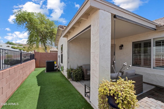 view of property exterior with stucco siding, central air condition unit, and a patio area
