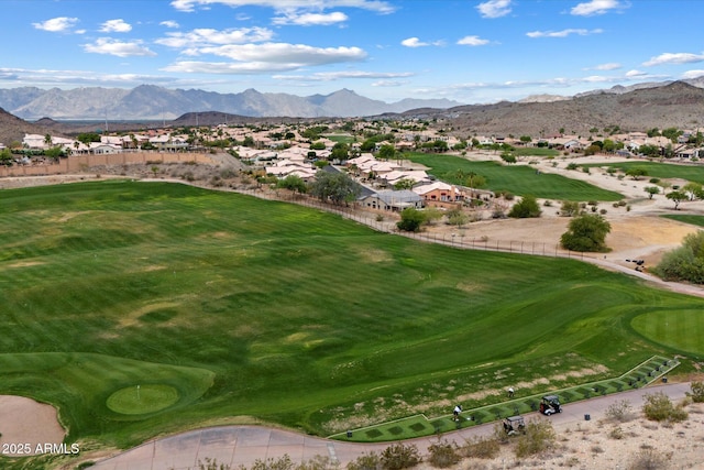 aerial view of residential area featuring mountains and a local golf course