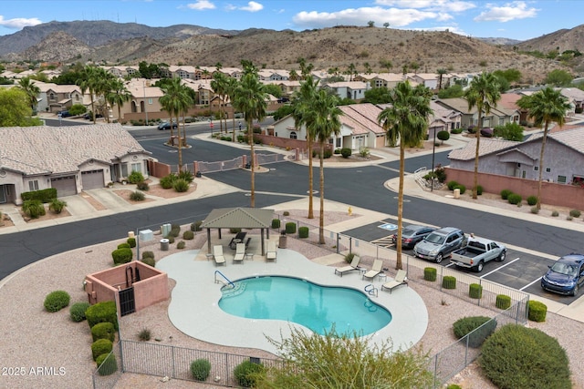 community pool featuring a residential view, a gazebo, and fence