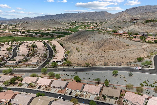aerial view of property and surrounding area featuring mountains and nearby suburban area