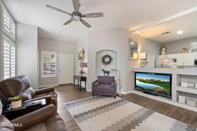 living room featuring ceiling fan, dark wood-type flooring, and baseboards