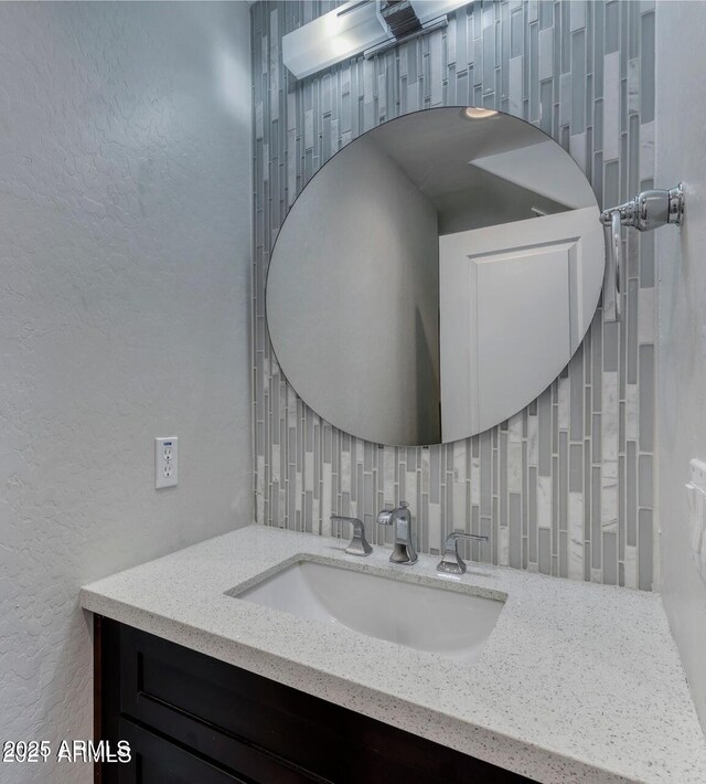 815 E Rose Ln Unit 105, Phoenix, AZ 85014 - bathroom with backsplash, vanity, and a textured wall