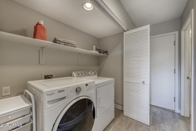 815 E Rose Ln Unit 105, Phoenix, AZ 85014 - laundry room featuring washer and clothes dryer, light wood-style flooring, and laundry area