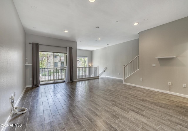 815 E Rose Ln Unit 105, Phoenix, AZ 85014 - unfurnished living room featuring baseboards, recessed lighting, and wood finished floors