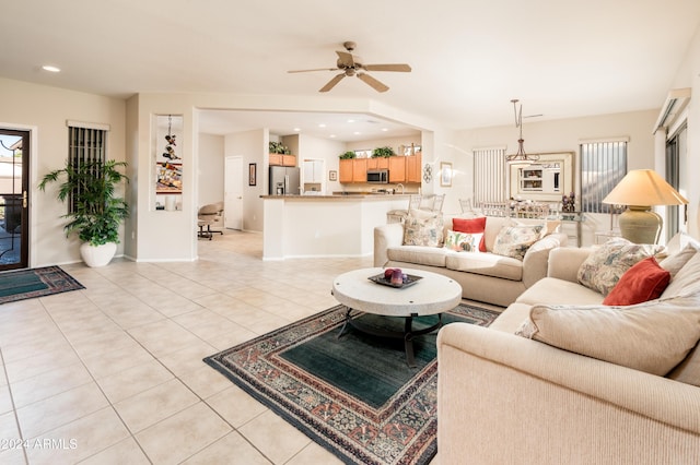 living room with ceiling fan and light tile patterned flooring