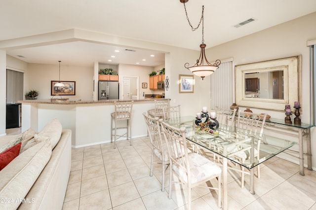 dining area with light tile patterned floors