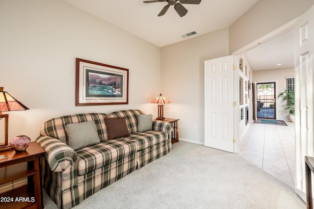 living room featuring light carpet and ceiling fan