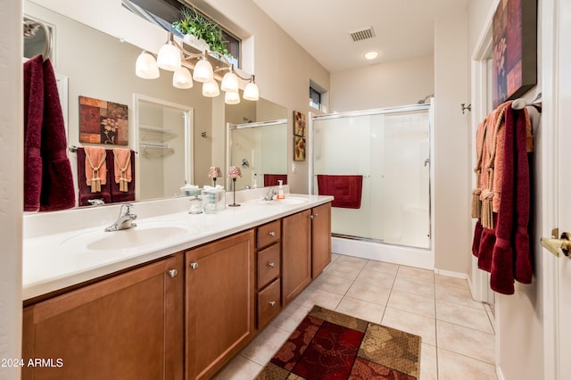 bathroom with tile patterned flooring, vanity, and an enclosed shower