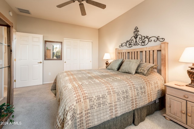 bedroom featuring ceiling fan, light colored carpet, and a closet