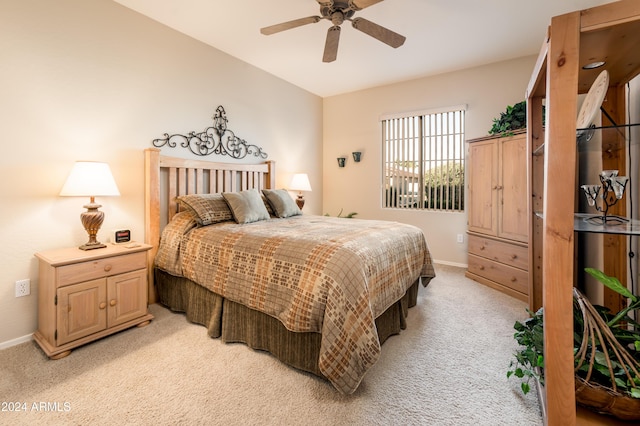 bedroom with ceiling fan and light carpet