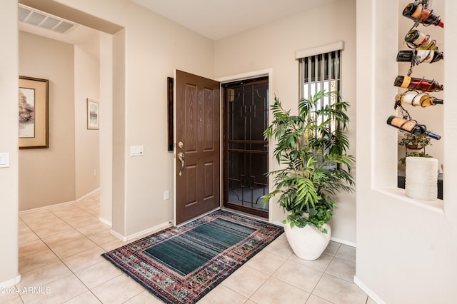 entryway with light tile patterned flooring