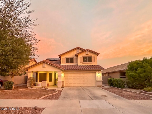 view of front of home featuring solar panels and a garage