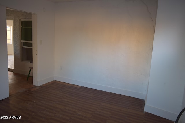 unfurnished room with dark hardwood / wood-style floors