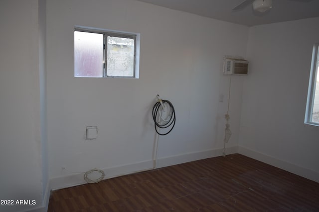 laundry room with dark hardwood / wood-style flooring, ceiling fan, and a wall mounted AC