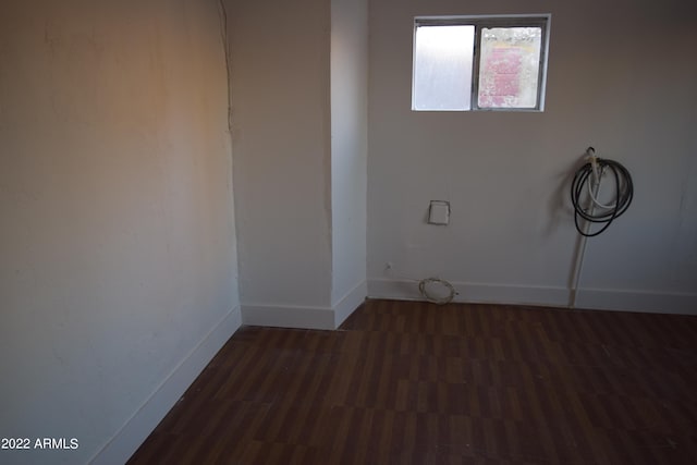 empty room with dark wood-type flooring