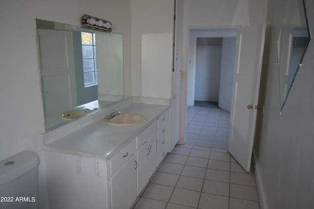 bathroom with tile floors, toilet, and vanity