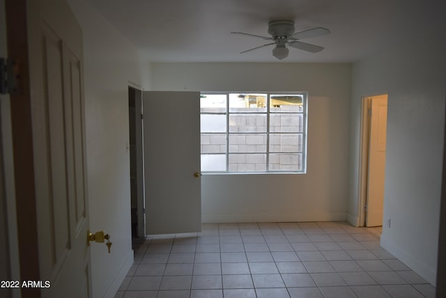 tiled empty room with ceiling fan