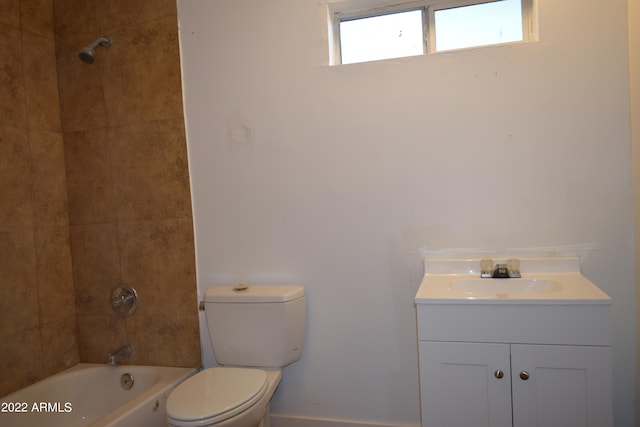 full bathroom with tiled shower / bath combo, toilet, and vanity