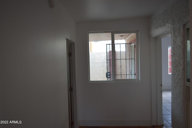 entryway with plenty of natural light and light tile flooring