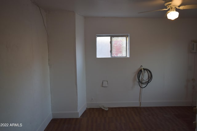 unfurnished room with ceiling fan and dark wood-type flooring