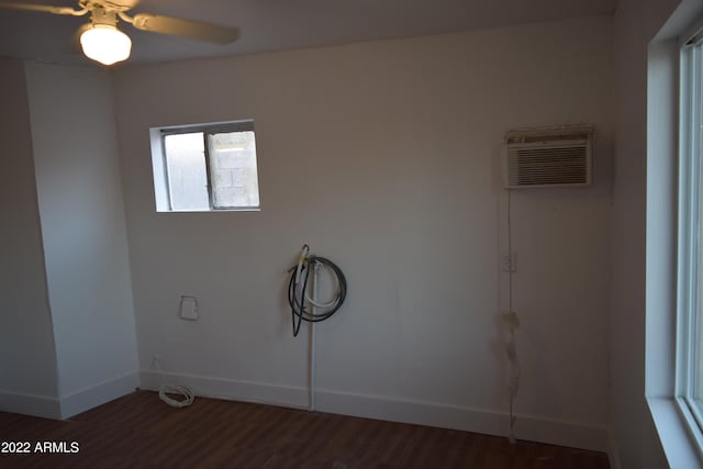 washroom with ceiling fan, dark wood-type flooring, and a wall mounted air conditioner