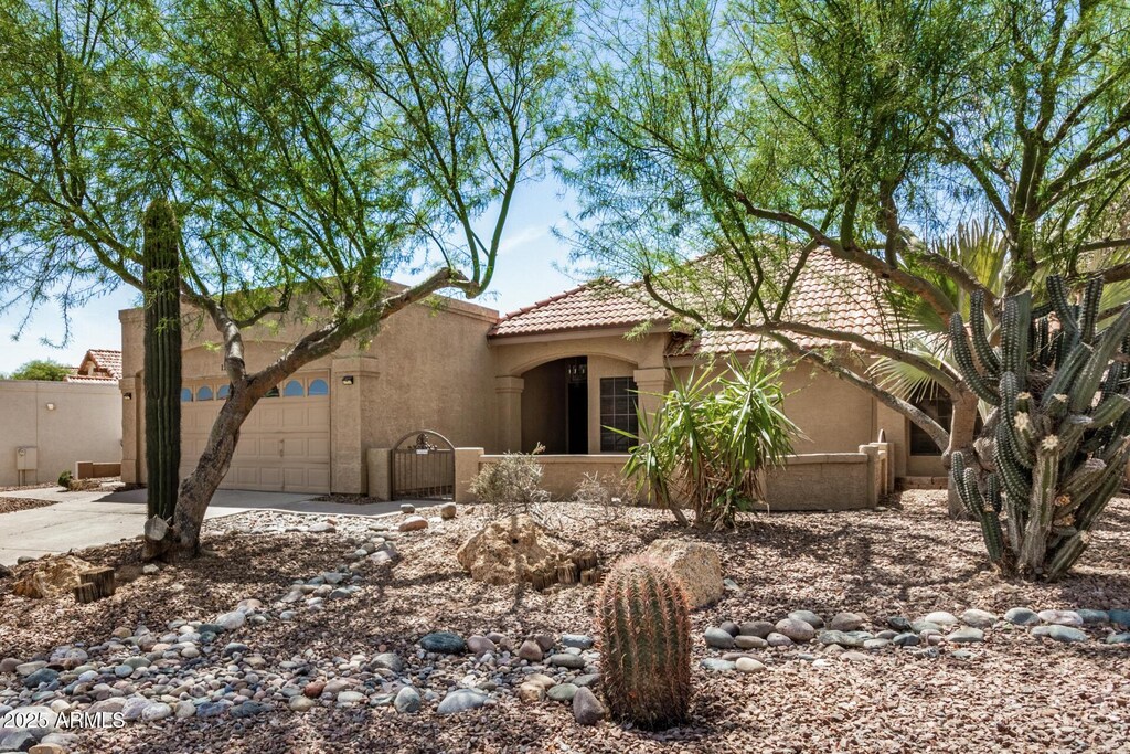 15238 S 36th Pl, Phoenix, AZ 85044 - view of front facade featuring a tiled roof, concrete driveway, stucco siding, and an attached garage