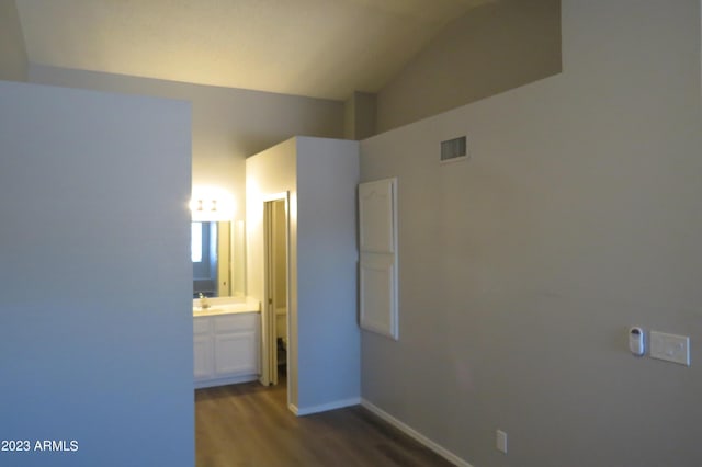 2301 E University Dr Unit 334, Mesa, AZ 85213 - unfurnished room with dark wood-style flooring, vaulted ceiling, a sink, and baseboards