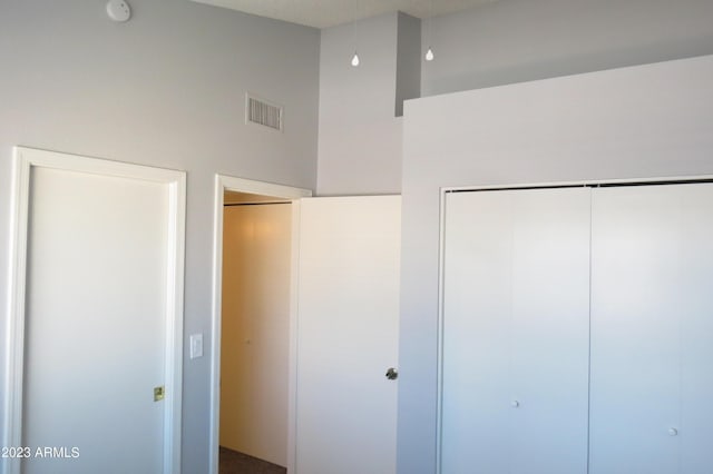 2301 E University Dr Unit 334, Mesa, AZ 85213 - unfurnished bedroom featuring a closet and a high ceiling
