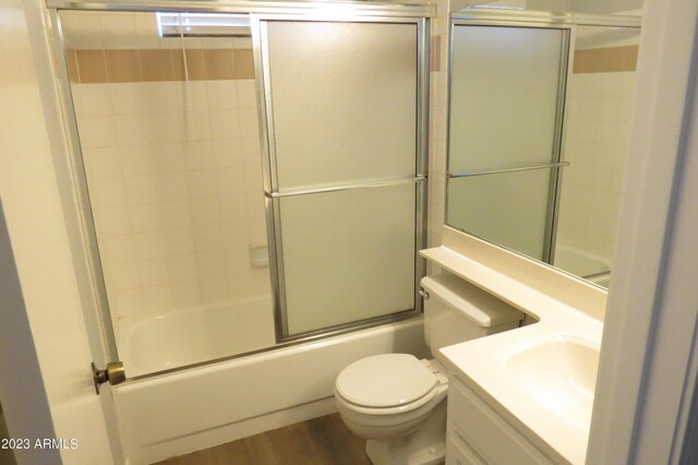 2301 E University Dr Unit 334, Mesa, AZ 85213 - bathroom with toilet, vanity, bath / shower combo with glass door, and wood finished floors