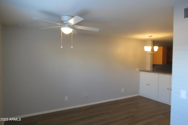 2301 E University Dr Unit 334, Mesa, AZ 85213 - empty room featuring ceiling fan, a chandelier, dark wood finished floors, and baseboards