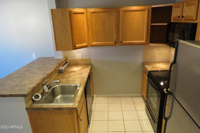 2301 E University Dr Unit 334, Mesa, AZ 85213 - kitchen featuring black appliances, a sink, a peninsula, baseboards, and light tile patterned floors