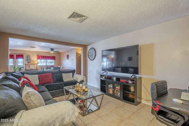 living room featuring light tile patterned flooring and a textured ceiling