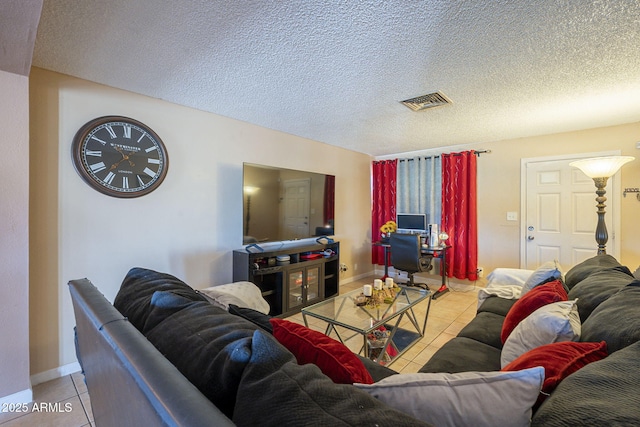 living room with light tile patterned floors and a textured ceiling