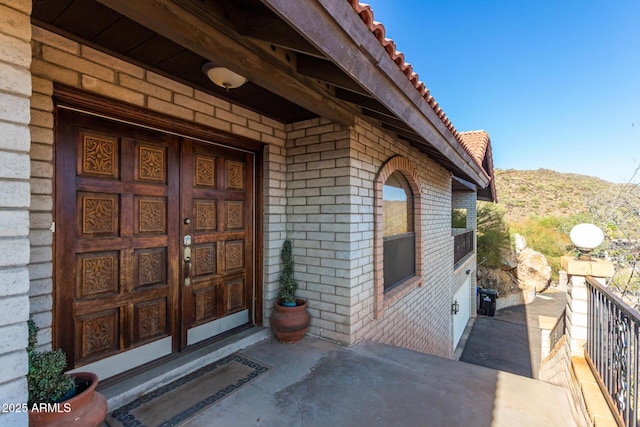 11237 N 15th Ln, Phoenix, AZ 85029 - doorway to property with brick siding, a mountain view, and a tile roof