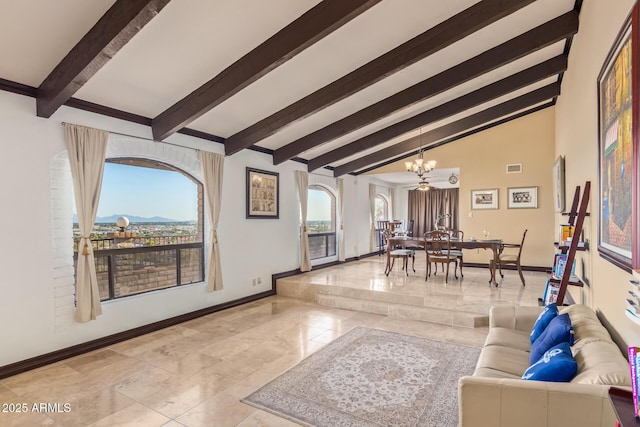 11237 N 15th Ln, Phoenix, AZ 85029 - living room featuring a chandelier, baseboards, tile patterned flooring, and arched walkways