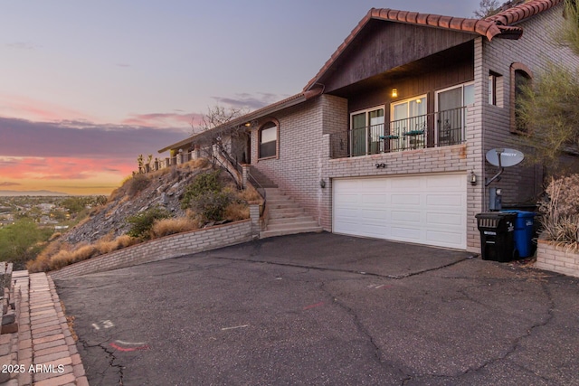 11237 N 15th Ln, Phoenix, AZ 85029 - view of front facade with driveway, an attached garage, brick siding, and stairs