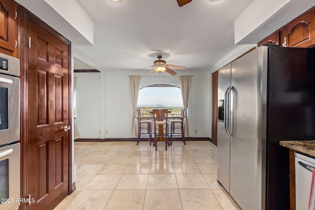 11237 N 15th Ln, Phoenix, AZ 85029 - kitchen featuring stainless steel appliances, a ceiling fan, baseboards, and light tile patterned floors