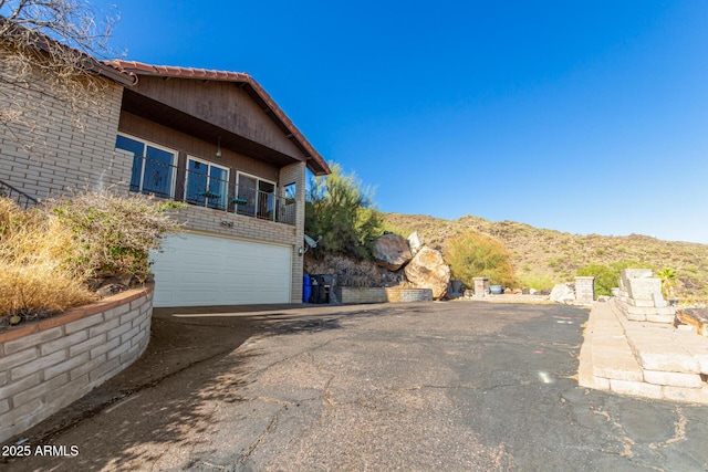11237 N 15th Ln, Phoenix, AZ 85029 - view of property exterior with an attached garage, asphalt driveway, and a mountain view