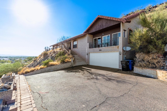 11237 N 15th Ln, Phoenix, AZ 85029 - view of side of property featuring driveway, a garage, stairway, and brick siding
