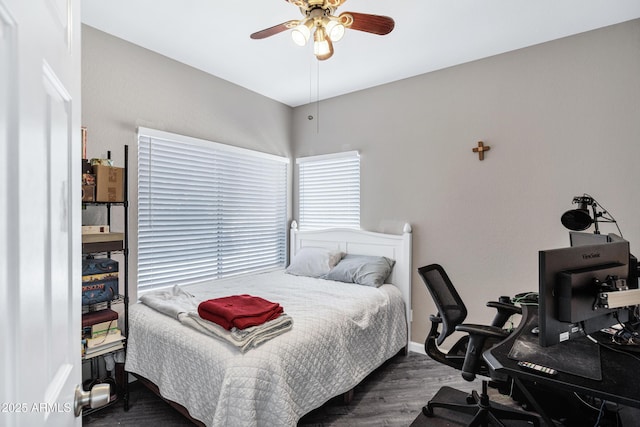 bedroom featuring ceiling fan, baseboards, and wood finished floors