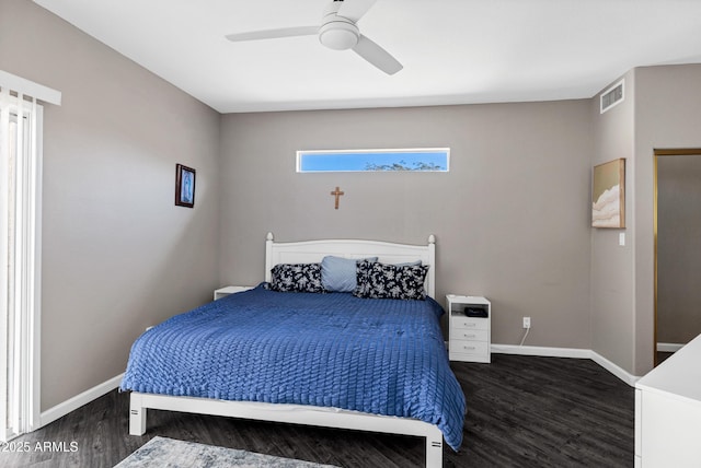 bedroom featuring a ceiling fan, visible vents, baseboards, and wood finished floors