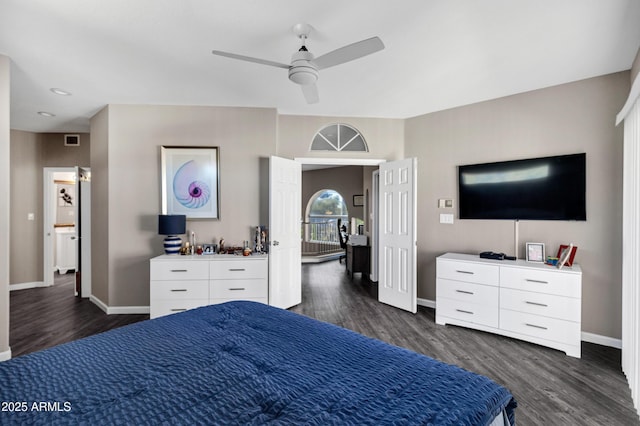 bedroom with dark wood-style floors, ceiling fan, and baseboards