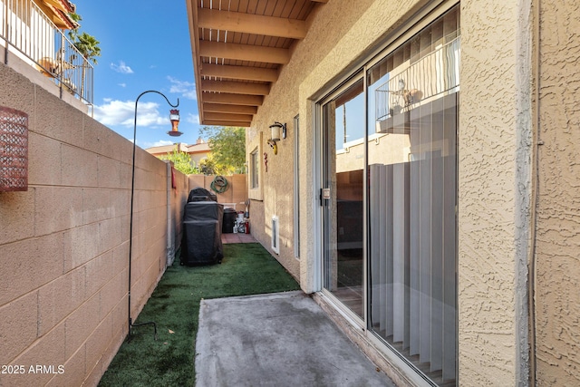 exterior space featuring a fenced backyard and stucco siding