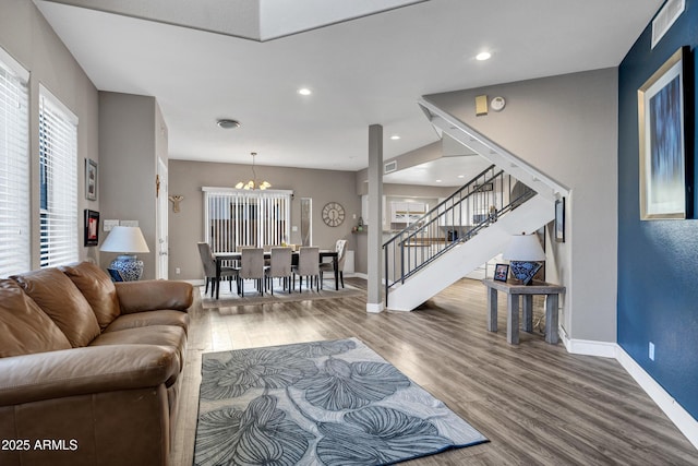 living room featuring recessed lighting, wood finished floors, visible vents, baseboards, and stairway