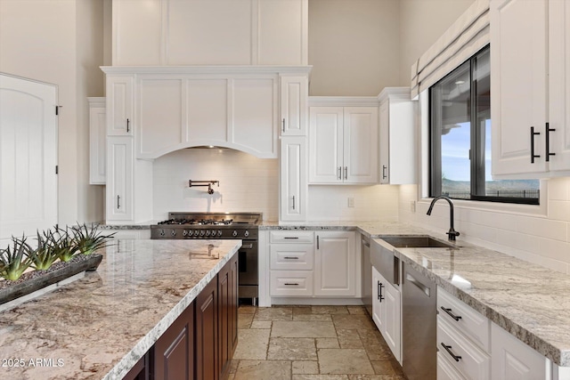 kitchen featuring white cabinetry, stone tile flooring, and appliances with stainless steel finishes