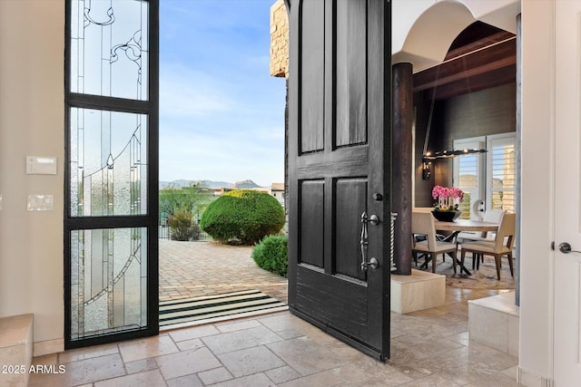 foyer featuring stone tile flooring