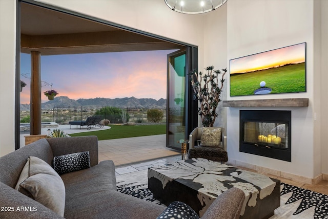 living area with a glass covered fireplace and a mountain view